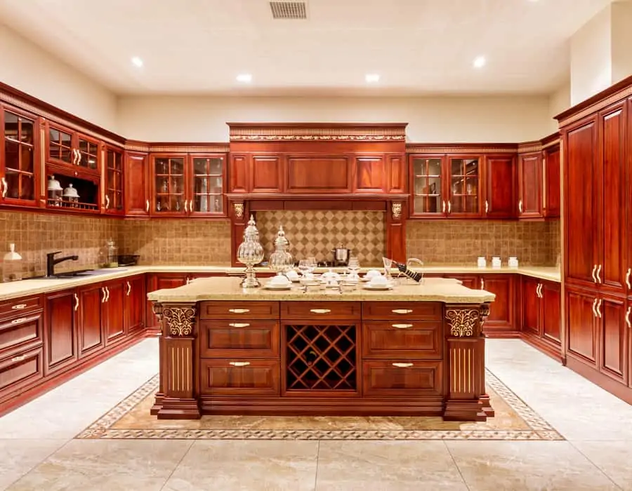 backlit kitchen with red wood cabinets